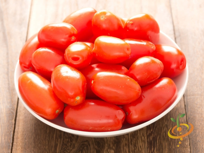 Rio Grande Tomato Seeds (Determinate) | Bowl of bright red, egg-shaped Rio Grande tomatoes on wooden surface