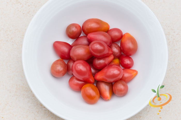 Red Pear Tomato Seeds | Red Pear Tomato fruits in white bowl showing small, ripe, pear-shaped red tomatoes.